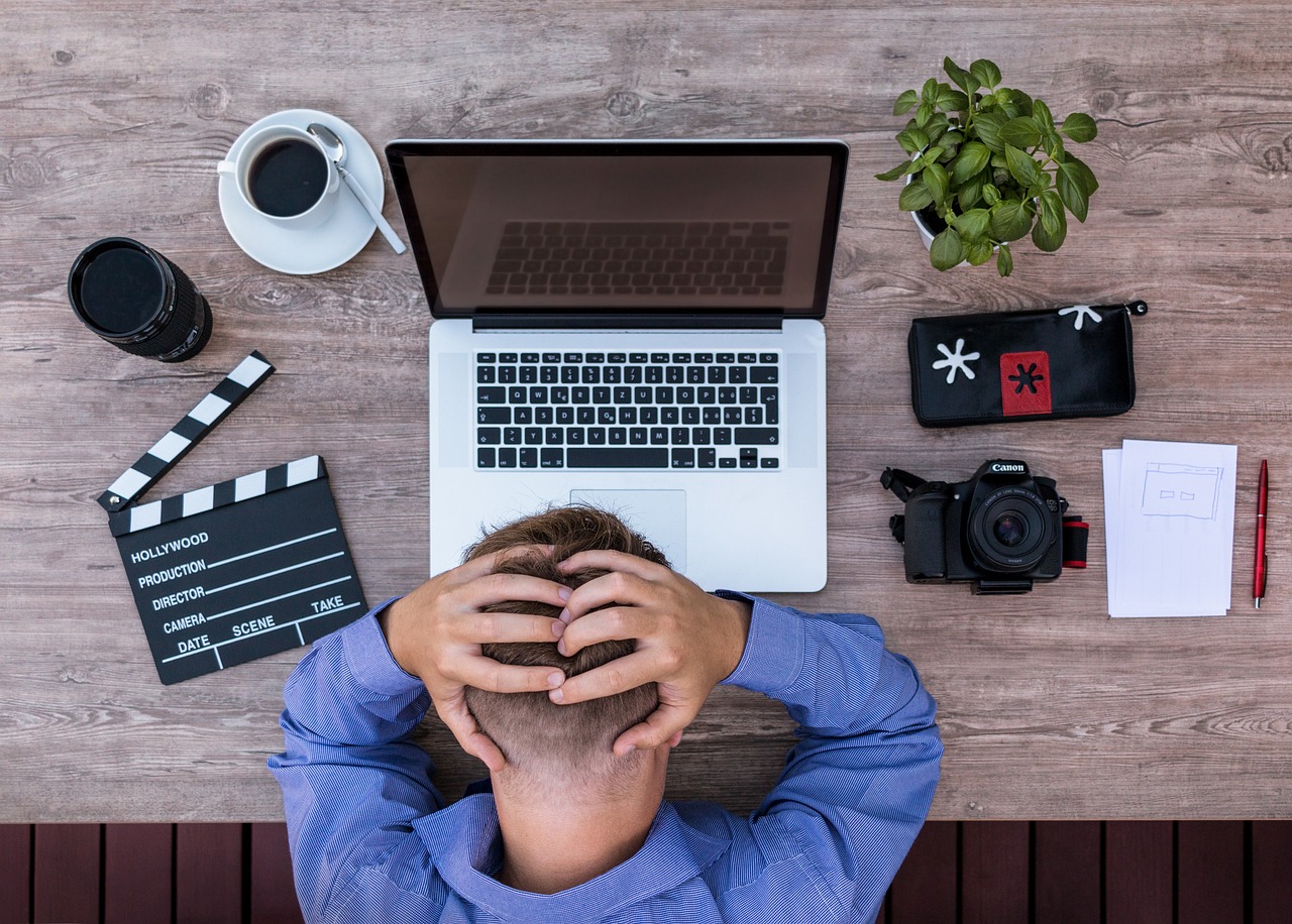 frustrated worker at a desk in front of their computer